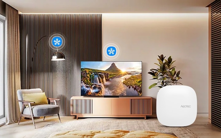 Aeotec Smart Home Hub 2 avec un téléviseur en arrière-plan
