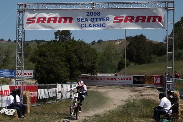 Greg Minnaar wheelies across the line