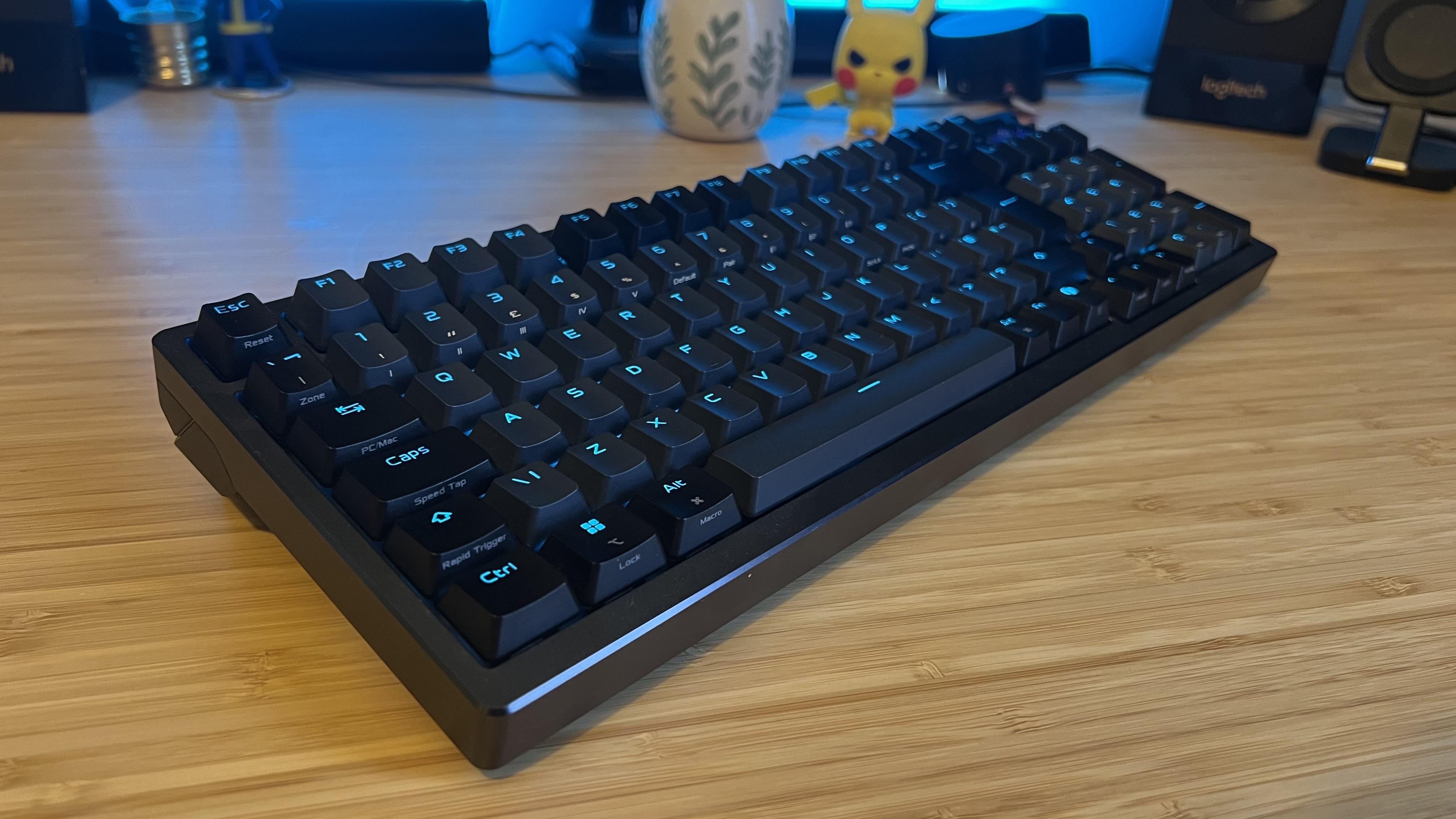 Asus ROG Azoth HE gaming keyboard on a wooden desk