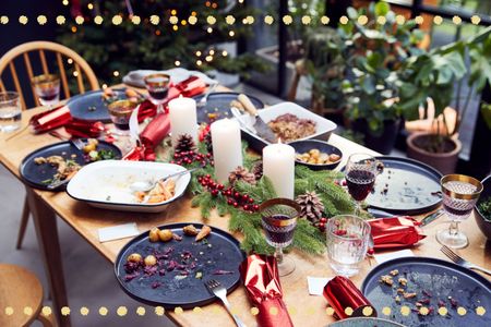 Christmas dinner table with empty plates, scraps and Christmas leftovers