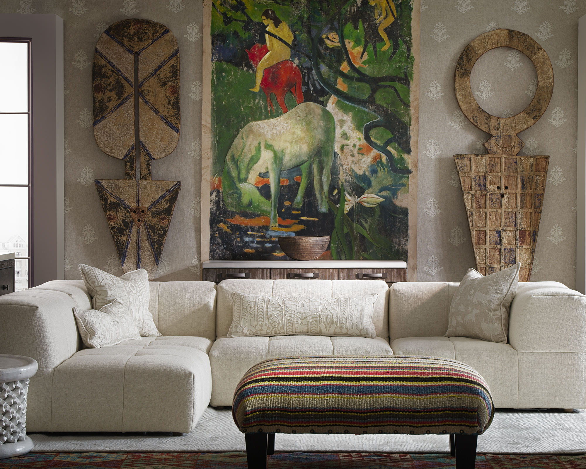 low white sofa in an eclectic living room with big art behind it on the wall