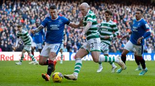 Ryan Jack of Rangers and Aaron Mooy of Celtic challenge for the ball during the Scottish Premiership match between Rangers and Celtic at Ibrox on January 2, 2023 in Glasgow, United Kingdom.