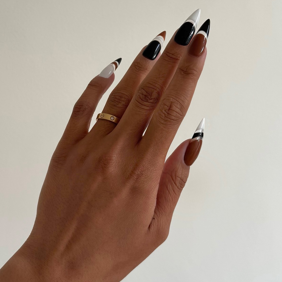A black, white, and caramel manicure by Iram Shelton