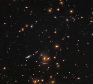 This Hubble Space Telescope photo shows a wide view of the galaxy cluster SDSS J0952+3434, which includes three that form a cosmic smiley face.
