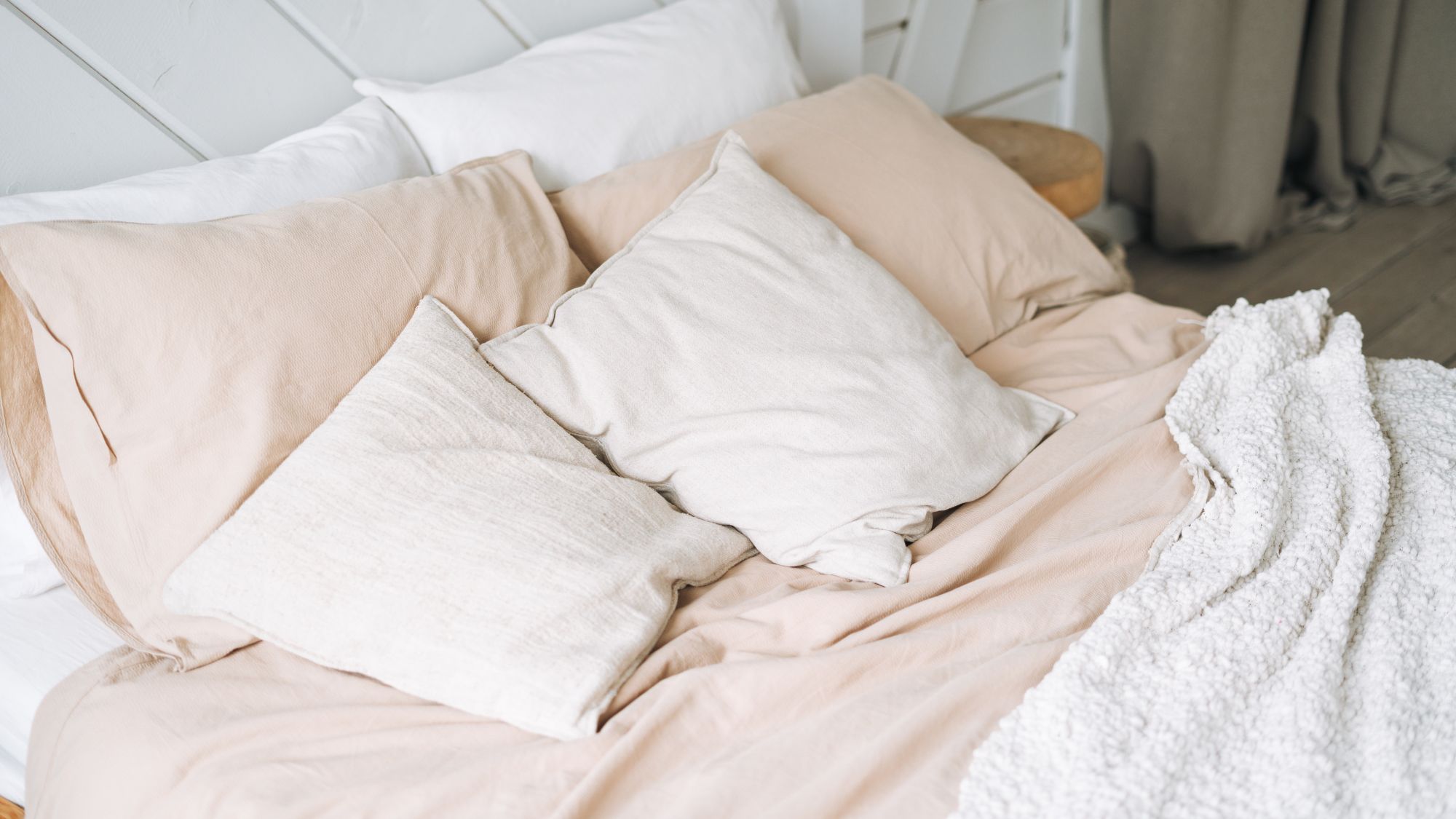 Six cushions and pillows on a bed