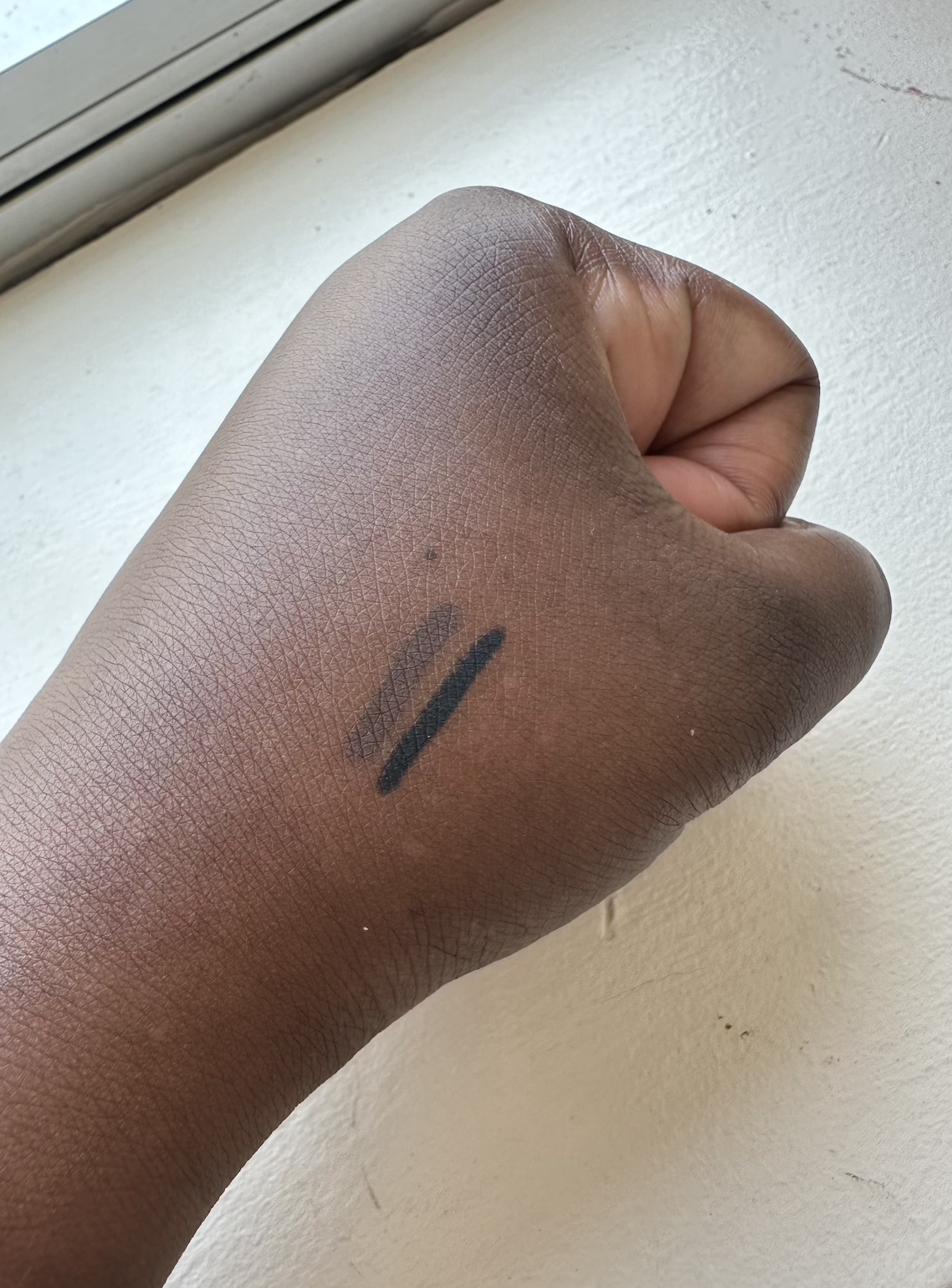 black and brown swatches of Kulfi Underlined Kajal Clean Waterproof Long-Wear Eyeliner on back of hand