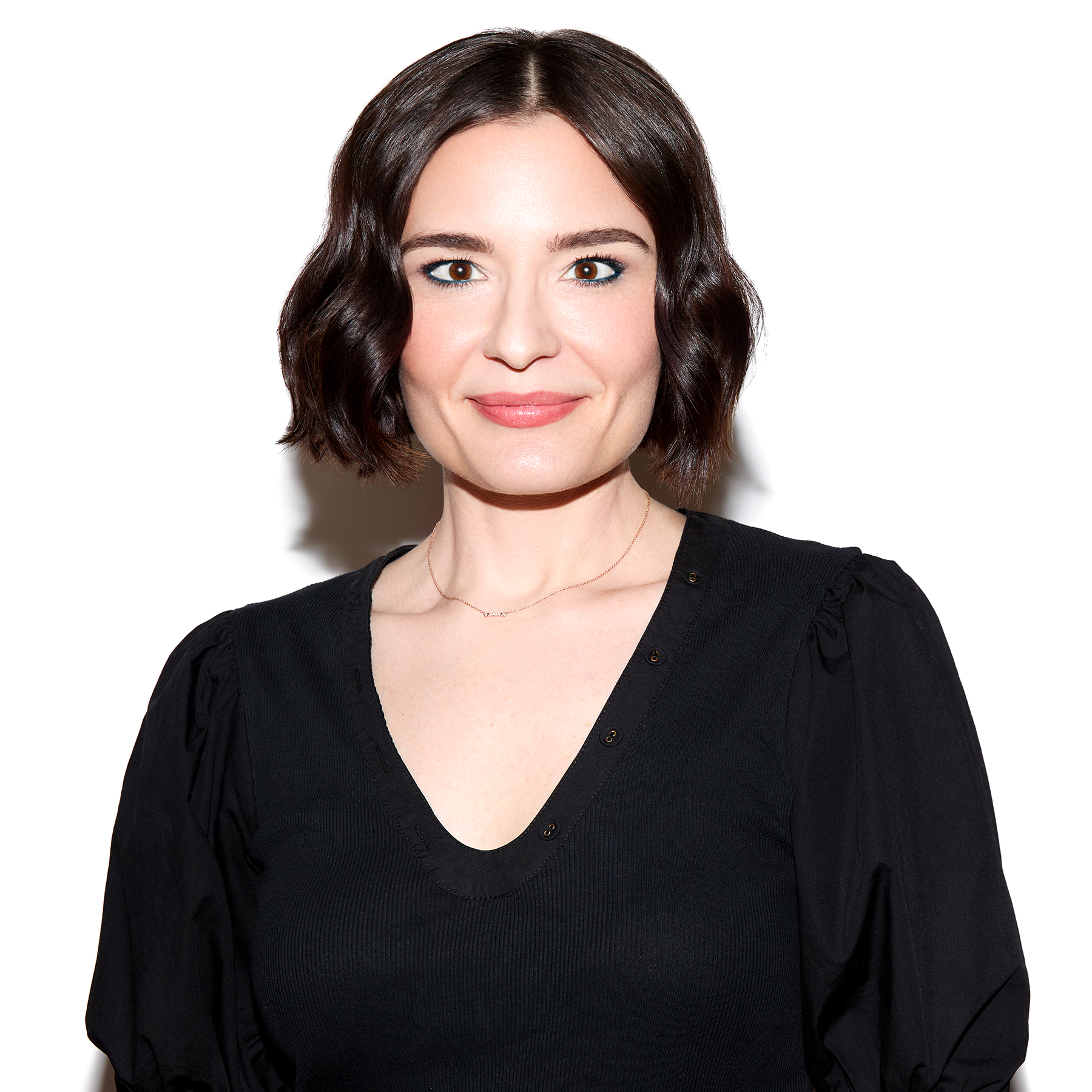 a white woman with short black hair in a black sweater