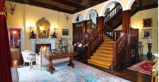 The Georgian house at Courtdown Demesne boasts high ceilings, ornate archways and open fireplaces, as seen in the hall.