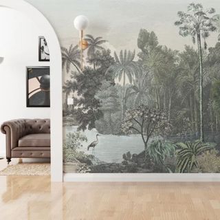 A mural on a wall depicting a vintage jungle scene, through an arch you can see a sofa