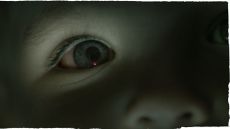 A close up of a child's eye that's blue. The image has a blue tint