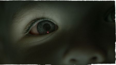 A close up of a child's eye that's blue. The image has a blue tint