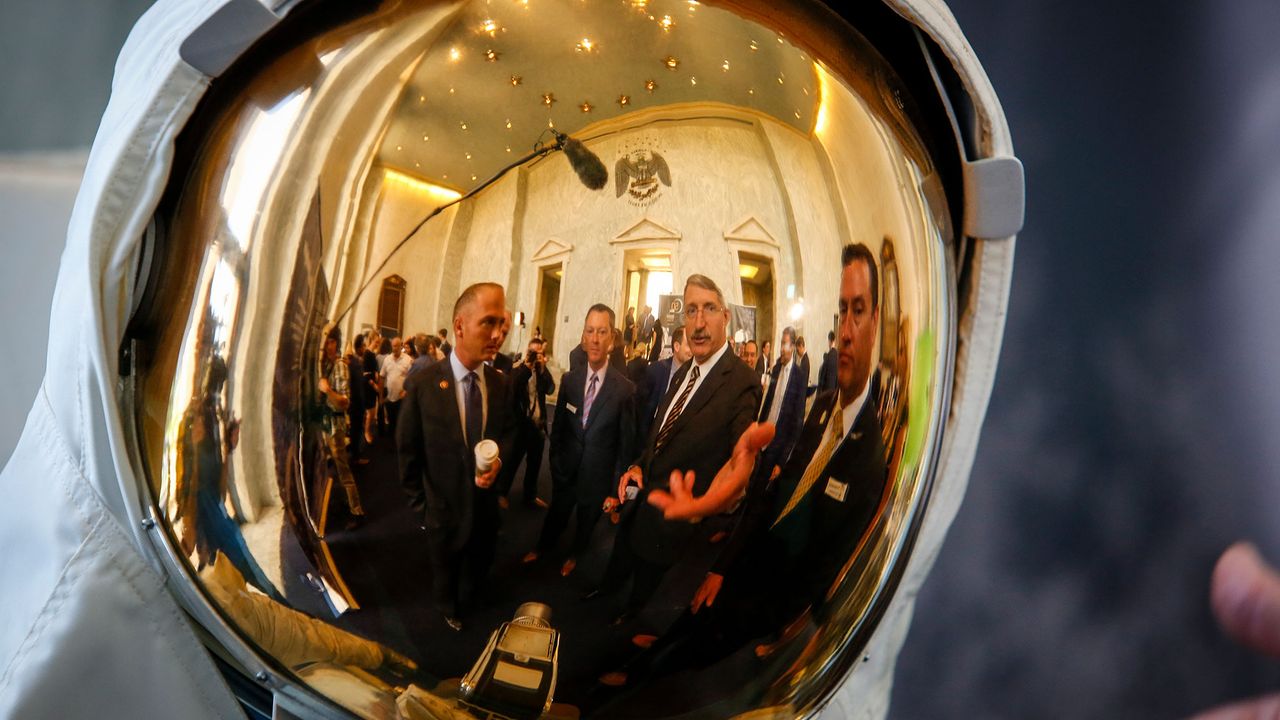 Rep. William Timmons (R-SC), left, in reflection, listens to former astronaut Dan Burbank talk about spacesuits as the prototype of Collins Aerospace, a unit of United Technologies Corp.'s Next Generation Space Suit system, is unveiled during the Space Day on the Hill on Thursday, July 25, 2019 in Washington. The showcase was timed to commemorate the 50th Anniversary of Apollo 11.