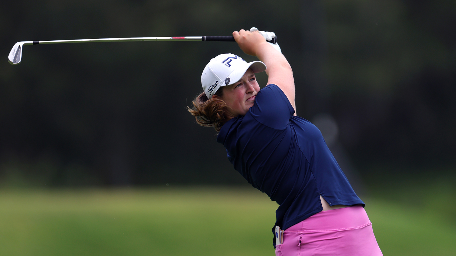 Lottie Woad hits an iron into the green