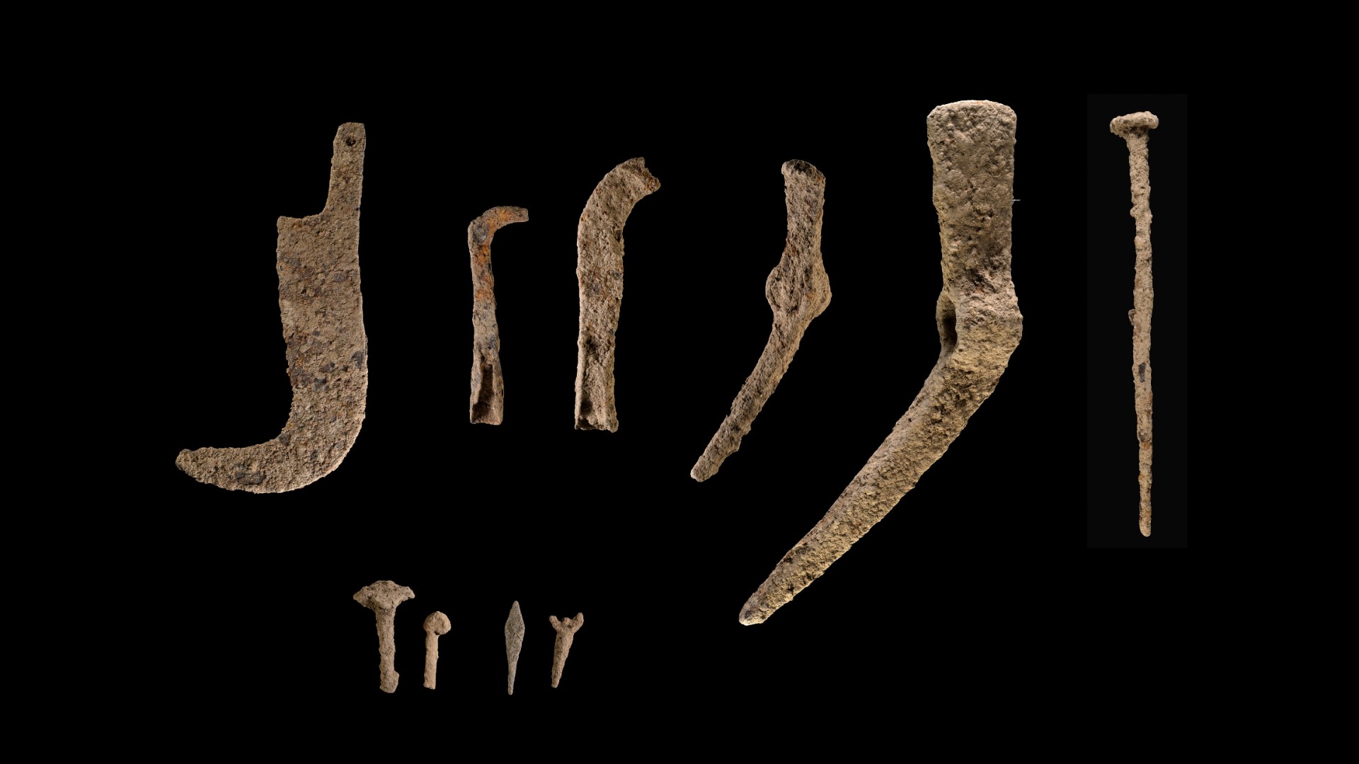 This image shows a selection of agricultural implements made from iron (such as picks and scythes) that were found in the ruins of a farmstead in northern Israel.