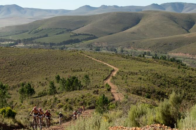 A line of riders climb a steep hill during stage 5