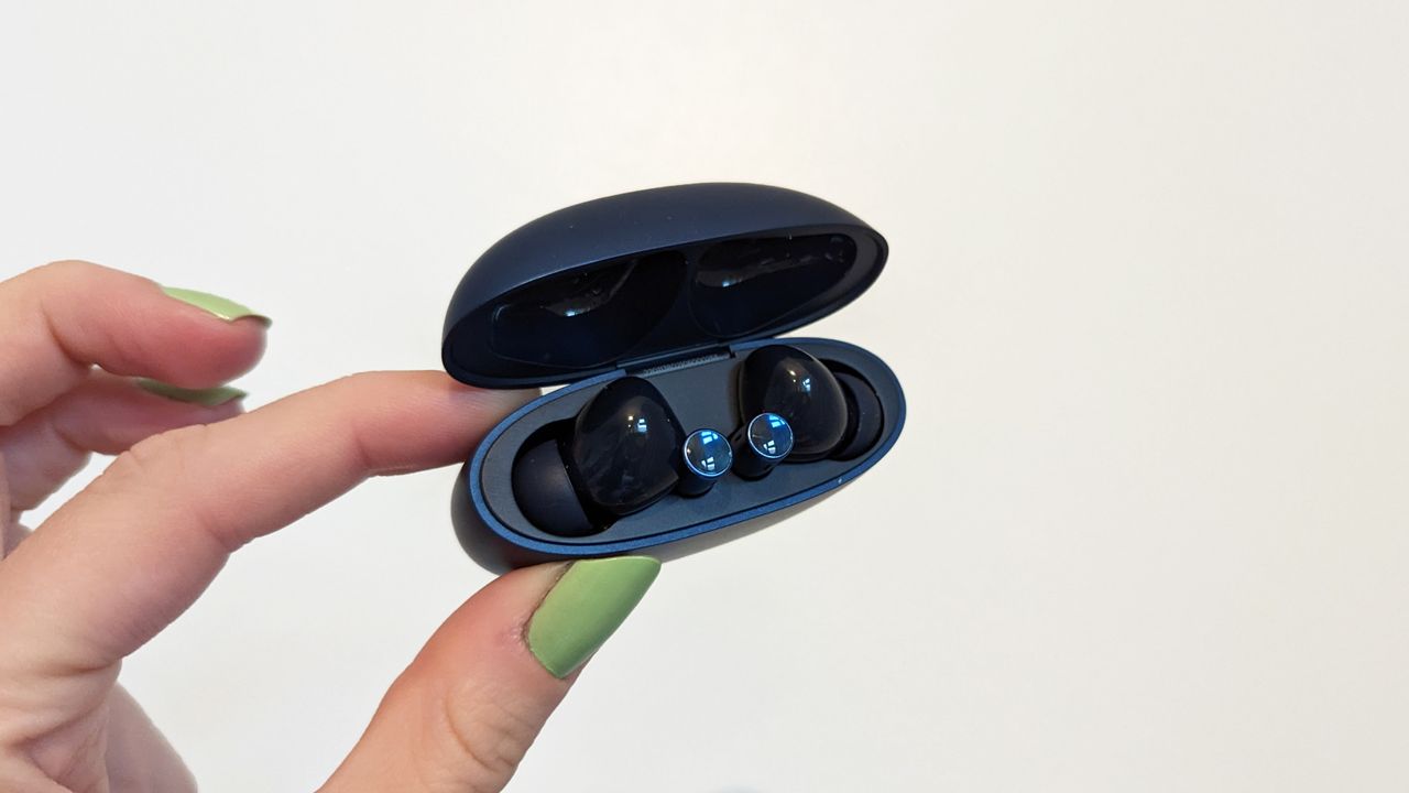 Realme Buds Air 3 review: earbuds in charging case held up against a wall