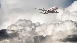 Passenger airplane flying in stormy clouds and air turbulence.