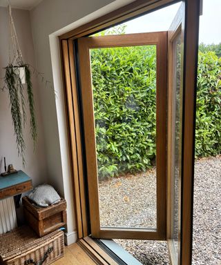 composite bifold doors with hanging plant in corner