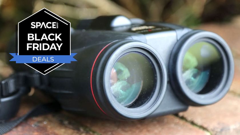 A pair of the Canon 10x42L IS WP binoculars on a brick wall with a Space.com Black Friday Deals badge in the left upper corner.