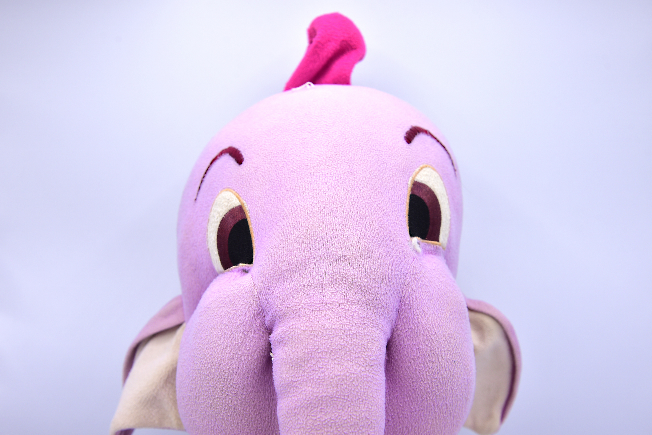 A soft elefant toy that looks like a Heffalump from Winnie the Pooh.