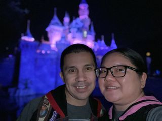 Christine and Robert take a portrait mode selfie in front of Sleeping Beauty Castle at Disneyland