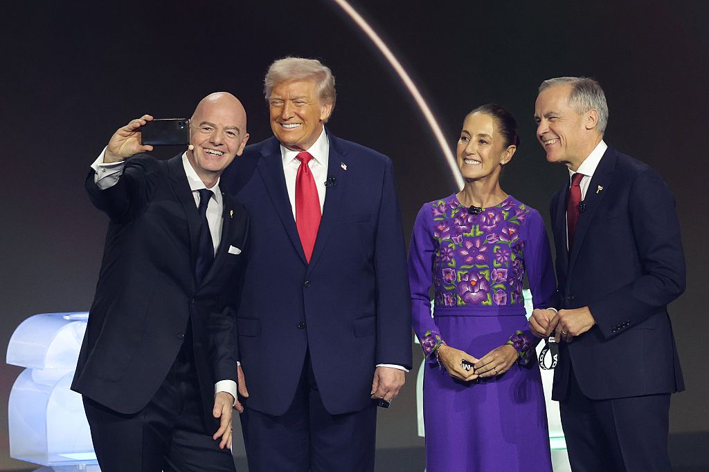 U.S. President Donald Trump, Claudia Sheinbaum, President of Mexico, and Mark Carney, Prime Minister of Canada, pose for a selfie with Gianni Infantino, President of FIFA, during the FIFA World Cup 2026 Official Draw at John F. Kennedy Center for the Performing Arts on December 05, 2025 in Washington, DC