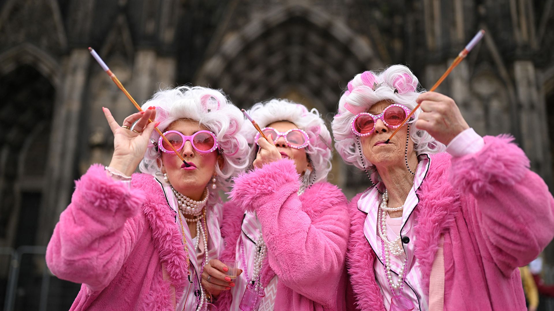
                                Revellers pose for a photo during Women's Carnival Day street party in Cologne, Germany
                            