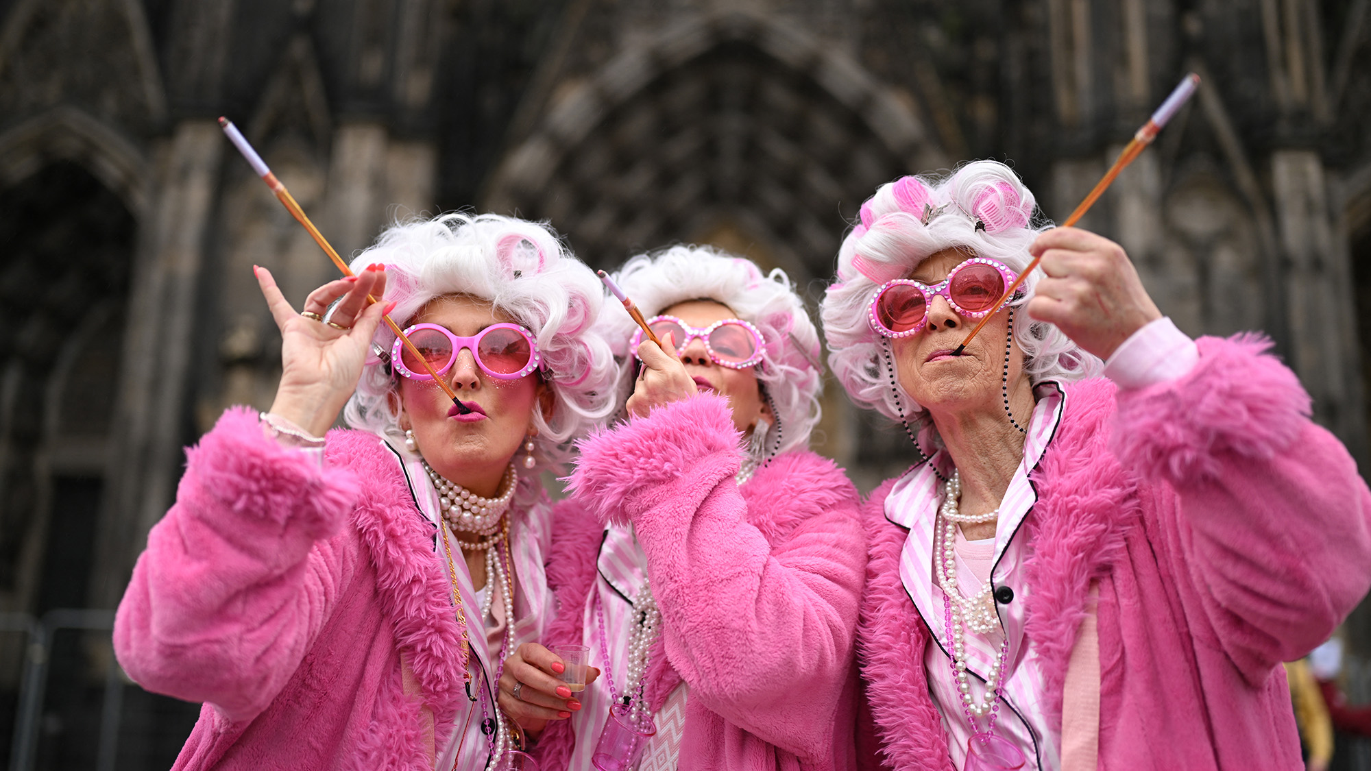 Revellers pose for a photo during Women's Carnival Day street party in Cologne, Germany