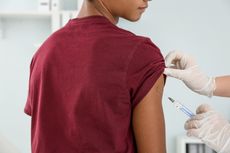 A teenager being vaccinated.