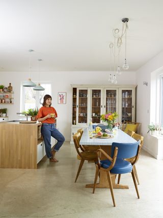 Modern open-plan kitchen with vintage dresser and dining room furniture