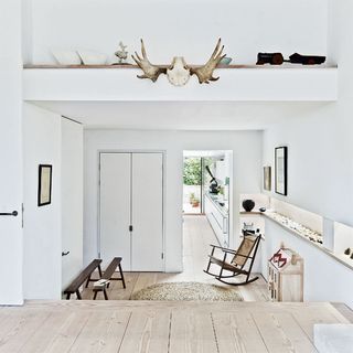 living room with white walls and wooden flooring