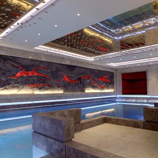 indoor basement pool with stone fixtures