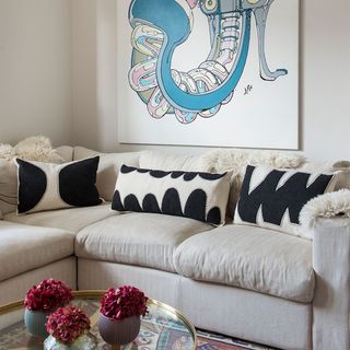 living room with neutral sofa and wall art