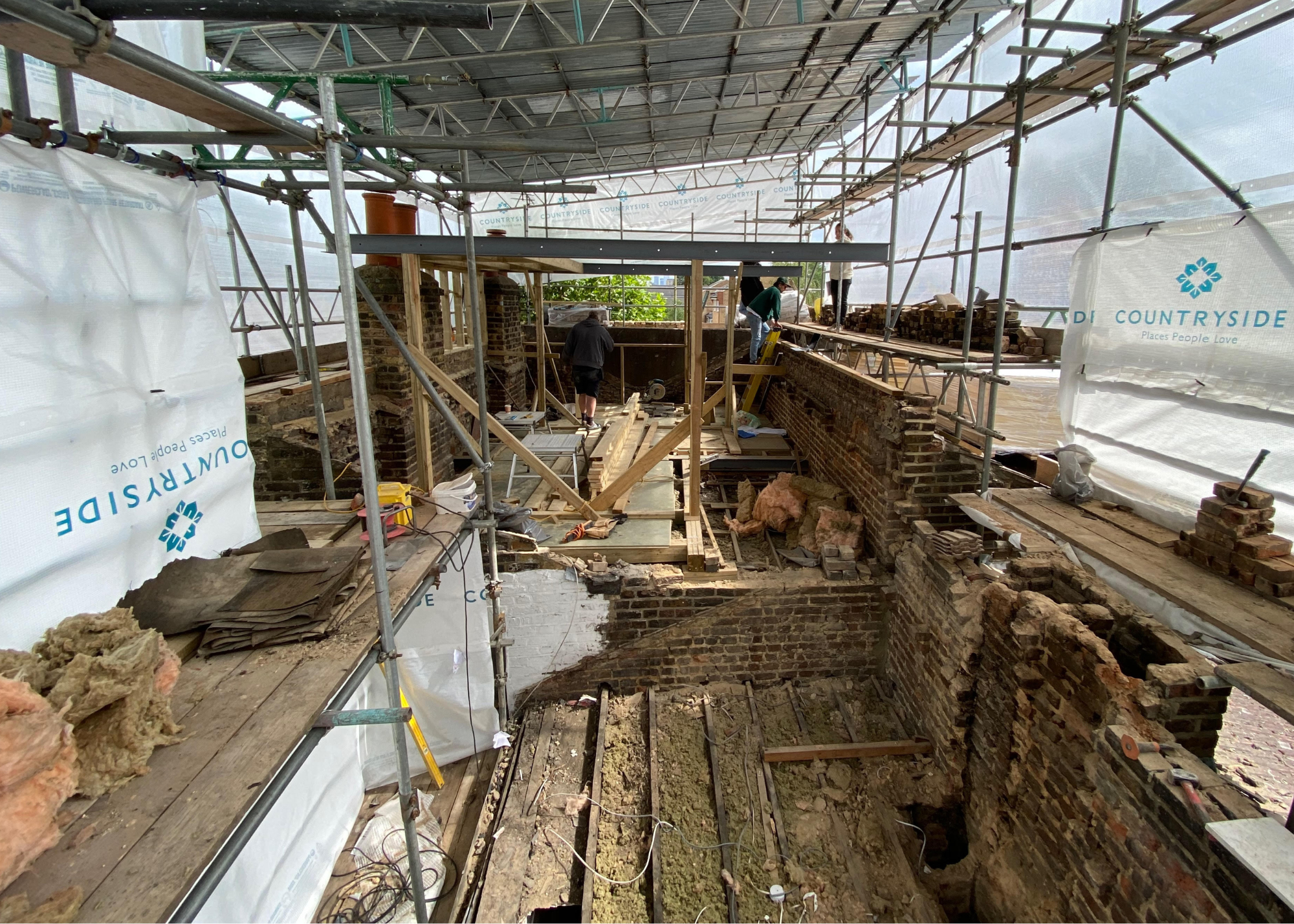 loft conversion process with scaffolding bricks and wood