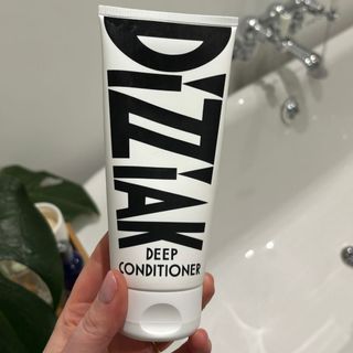 Laura holding Dizziak Deep Conditioner - best hair conditioners