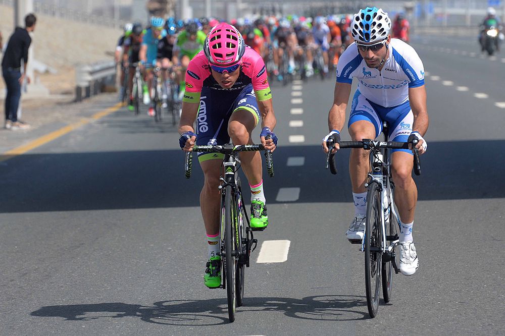 Two riders try to escape the peloton