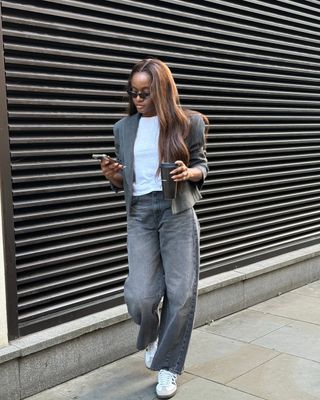 @mimi.orere wears barrel leg jeans and trainers