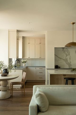 a light beige kitchen in an open plan space