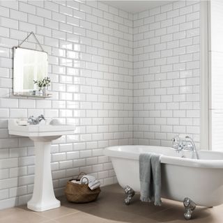bathroom with white tiles sink and bathtub