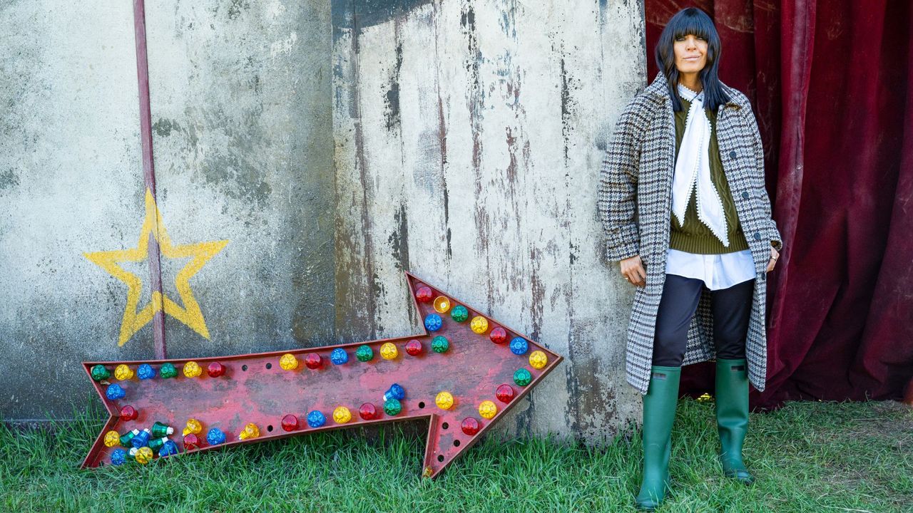 Claudia Winkleman in a check coat and wellies 