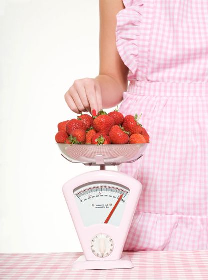 Woman-weighing-strawberries photo