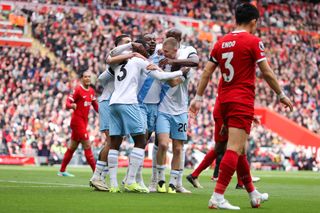 Eberechi Eze of Crystal Palace celebrates after scoring his side's first goal during the Premier League match between Liverpool FC and Crystal Palace at Anfield on April 14, 2024 in Liverpool, England.