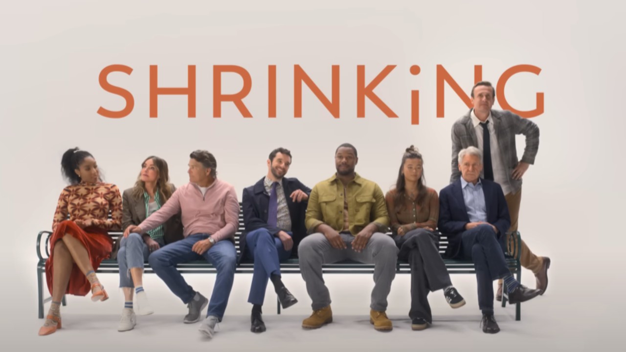 From left to right: Gaby, Liz, Derek, Brian, Sean, Alics and Paul sitting on a bench, Jimmy is standing and leaning on the right side of it.