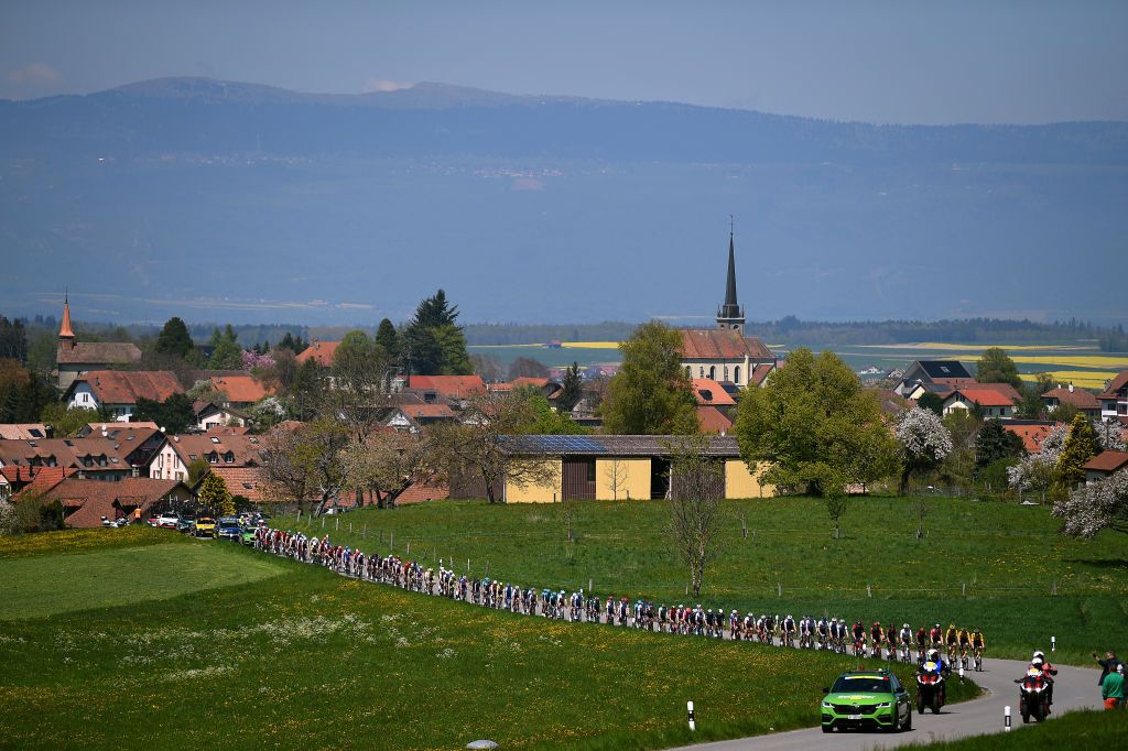 OULENSSOUSECHALLENS SWITZERLAND APRIL 28 A general view of the peloton passing through Froideville village landscape during the 75th Tour De Romandie 2022 Stage 2 a 1682km stage from challens to challens TDR2022 on April 28 2022 in OulenssousEchallens Switzerland Photo by Dario BelingheriGetty Images
