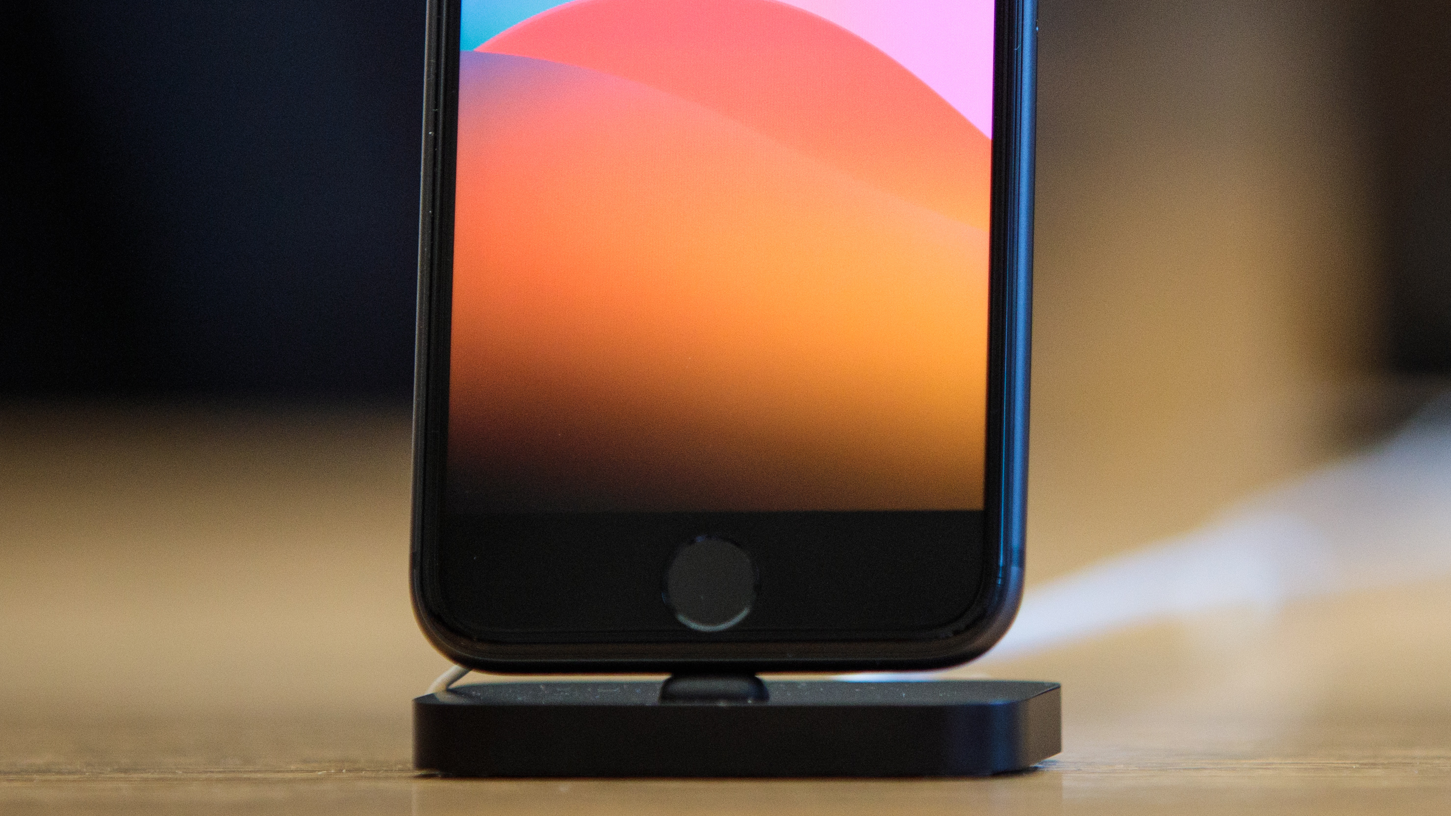 The circular home button on a black iPhone 5S, which houses the Touch ID sensor