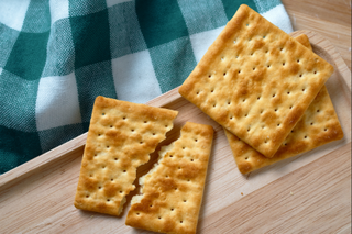 Plain crackers on a wooden board