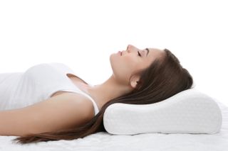Woman lying on a cervical pillow to support the head and reduce snoring