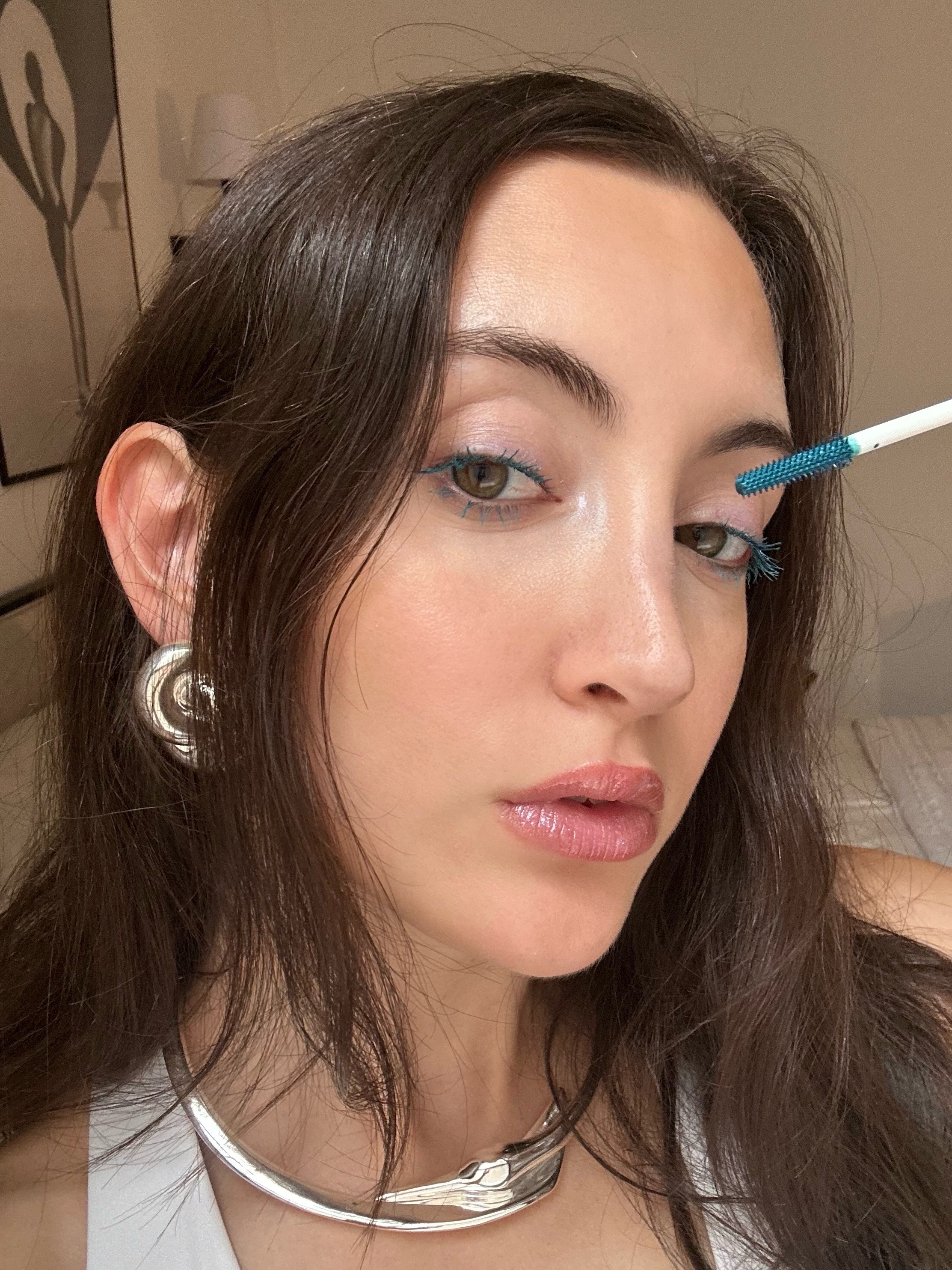 Alyssa Brascia wearing and applying the Half Magic Eyelectric Extreme Lengthening Mascara in Teal Widdit.