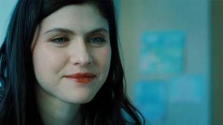Alexandra Daddario smiles and shows off her long tresses as Rowan in The Mayfair Witches.