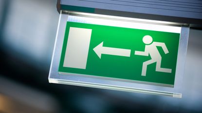 An exit sign shows the image of a man running toward a door.